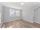 Simple bedroom with hardwood floors and two windows at 1200 Rogers Rd, Graham, NC 27253