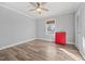 Bright bedroom featuring hardwood floors and a red dresser at 1200 Rogers Rd, Graham, NC 27253