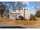 Ranch style home with a sunroom and mature trees in the yard at 1200 Rogers Rd, Graham, NC 27253
