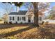 Charming ranch home with gray exterior, landscaping, and mature trees at 1200 Rogers Rd, Graham, NC 27253