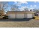 Two-car detached garage with extra storage space and a gravel driveway at 1200 Rogers Rd, Graham, NC 27253