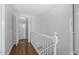 Clean hallway with white railings and wooden floors at 1200 Rogers Rd, Graham, NC 27253