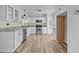 Modern kitchen with white cabinets, granite counters, and stainless steel appliances at 1200 Rogers Rd, Graham, NC 27253
