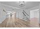 Spacious living area with hardwood floors and an open view of the kitchen and staircase at 1200 Rogers Rd, Graham, NC 27253