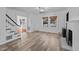 Bright living room featuring hardwood floors, fireplace, and built-in shelving at 1200 Rogers Rd, Graham, NC 27253
