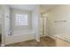 Bathroom with soaking tub, shower, and tile flooring at 1216 Magnolia Hill Rd, Garner, NC 27529