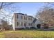 Two-story house with beige siding, red shutters, and a landscaped yard at 1216 Magnolia Hill Rd, Garner, NC 27529