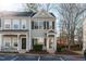 Two-story townhome with neutral siding and dark brown doors at 1316 Holly Grove Way, Durham, NC 27713