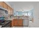 Open kitchen with stainless steel appliances and view to living room at 1316 Holly Grove Way, Durham, NC 27713