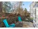 Small patio with two teal chairs and a side table at 1316 Holly Grove Way, Durham, NC 27713