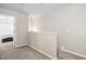 Upstairs hallway with carpet, leading to bedrooms and stairs at 1328 Regulator St, Raleigh, NC 27603