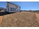 Spacious backyard with newly seeded grass and the back of a two-story home with white siding at 143 Steppe Way, Garner, NC 27529