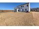 Large backyard with newly seeded grass and the back of a two-story home with white siding at 143 Steppe Way, Garner, NC 27529