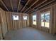 Unfinished basement room with framed walls and windows at 143 Steppe Way, Garner, NC 27529