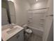 Clean bathroom featuring a vanity with quartz countertop and a shower-tub combo at 143 Steppe Way, Garner, NC 27529