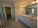Bright bathroom with dual sink vanity, walk-in shower, and vinyl plank flooring at 143 Steppe Way, Garner, NC 27529