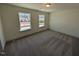 A sunlit bedroom with two windows, perfect for enjoying the views of the neighborhood at 143 Steppe Way, Garner, NC 27529