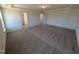 A large primary bedroom features neutral carpet, a tray ceiling and two doorways at 143 Steppe Way, Garner, NC 27529