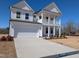 Attractive two-story home with a spacious driveway and beautifully landscaped front yard at 143 Steppe Way, Garner, NC 27529