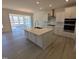 Well-appointed kitchen with a center island, stainless steel appliances, and open layout to dining area at 143 Steppe Way, Garner, NC 27529