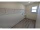 A bright laundry room features a window and plenty of shelving for storage and organization at 143 Steppe Way, Garner, NC 27529