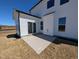 Concrete patio and back of a two-story home with a sunroom addition and white siding at 143 Steppe Way, Garner, NC 27529