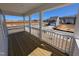 View of covered porch with wooden floor, white railings, and view of a new house at 143 Steppe Way, Garner, NC 27529