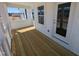 View of covered porch with wooden floor, white railings, and exterior door at 143 Steppe Way, Garner, NC 27529