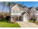 Two-story tan house with white shutters, a white door and a two-car garage at 152 Brentfield Loop, Morrisville, NC 27560