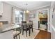 Bright dining area with table and chairs, view into living room with fireplace at 1699 Yorkshire Ln, Rocky Mount, NC 27803