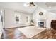 Bright living room with hardwood floors and fireplace at 1702 Grand Barton Ct, Apex, NC 27502