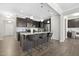 Modern kitchen with dark cabinetry, granite island, and hardwood floors at 207 Explorer Dr # 261, Morrisville, NC 27560