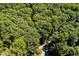 Aerial view of a wooded lot with a paved road at 2100 Tadley Dr, Chapel Hill, NC 27514