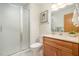 Clean bathroom with shower stall, single vanity, and wood cabinets at 2100 Tadley Dr, Chapel Hill, NC 27514