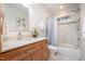 Clean bathroom, featuring a shower/tub combo and marble tile at 2100 Tadley Dr, Chapel Hill, NC 27514