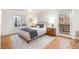 Bright bedroom with wood floors, plush bedding, and private access to a deck at 2100 Tadley Dr, Chapel Hill, NC 27514