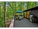 Spacious deck with seating area, umbrella, and grill, overlooking woods at 2100 Tadley Dr, Chapel Hill, NC 27514
