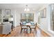 Modern dining area with hardwood floors, glass table, and views of the woods at 2100 Tadley Dr, Chapel Hill, NC 27514