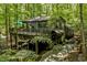 Mid-century modern home with a large deck and stone pathway nestled in a wooded lot at 2100 Tadley Dr, Chapel Hill, NC 27514