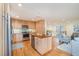 Updated kitchen features wood cabinets, stainless steel appliances, and an island at 2100 Tadley Dr, Chapel Hill, NC 27514