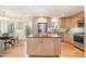 Modern kitchen with wood cabinets, stainless steel appliances, and large island at 2100 Tadley Dr, Chapel Hill, NC 27514