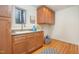 Bright laundry room with wood cabinets and granite countertop at 2100 Tadley Dr, Chapel Hill, NC 27514