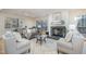 Bright living room featuring a fireplace, comfy seating, and large windows at 2100 Tadley Dr, Chapel Hill, NC 27514