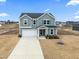Two-story house, gray siding, driveway, and backyard at 233 John Stark Dr, Fuquay Varina, NC 27526