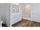 Bathroom featuring double sinks, a walk-in shower, and hardwood floors at 233 John Stark Dr, Fuquay Varina, NC 27526
