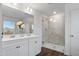 Elegant bathroom with double vanity, a large shower, and hardwood floors at 233 John Stark Dr, Fuquay Varina, NC 27526