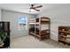 bedroom with twin-over-twin bunk bed, bookshelf, and window at 233 John Stark Dr, Fuquay Varina, NC 27526