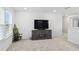Spacious bonus room with large TV, carpet, and plenty of natural light at 233 John Stark Dr, Fuquay Varina, NC 27526