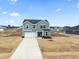 Two-story house exterior, gray siding, attached garage, and landscaping at 233 John Stark Dr, Fuquay Varina, NC 27526