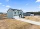 Two-story house exterior, gray siding, attached garage, and landscaping at 233 John Stark Dr, Fuquay Varina, NC 27526